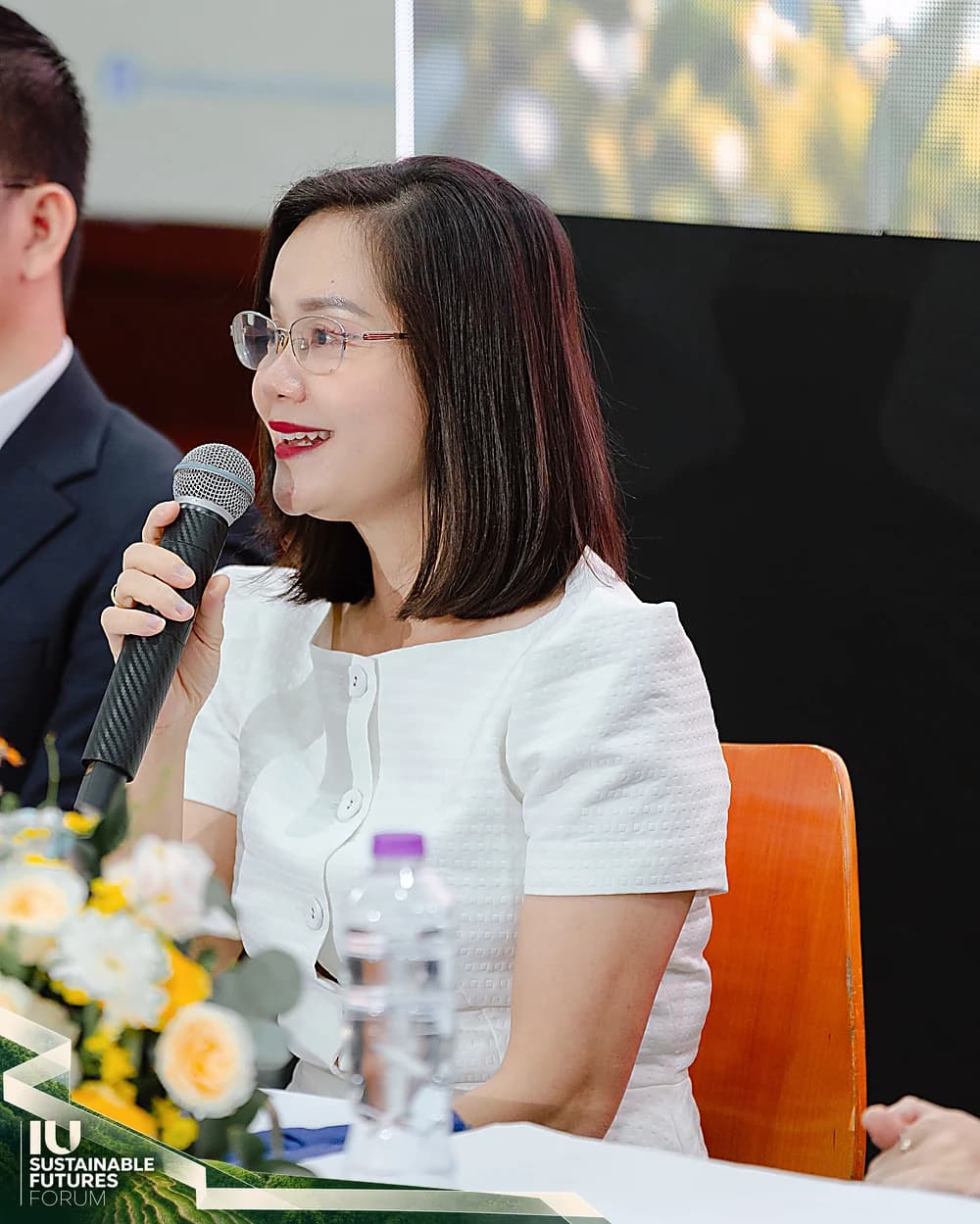 Chị Nguyễn Thị Hương Thu cầm micro chia sẻ tại bàn diễn giả
