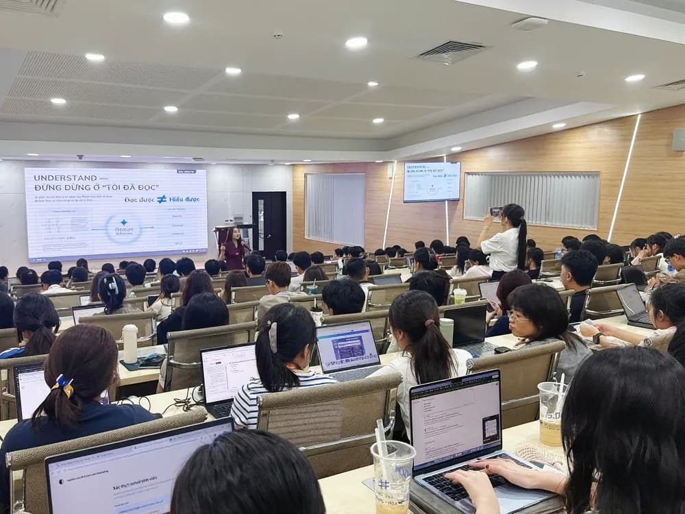 Chị Trần Tuyết Hương trình bày phần UNDERSTAND trước hội trường sinh viên đang dùng laptop